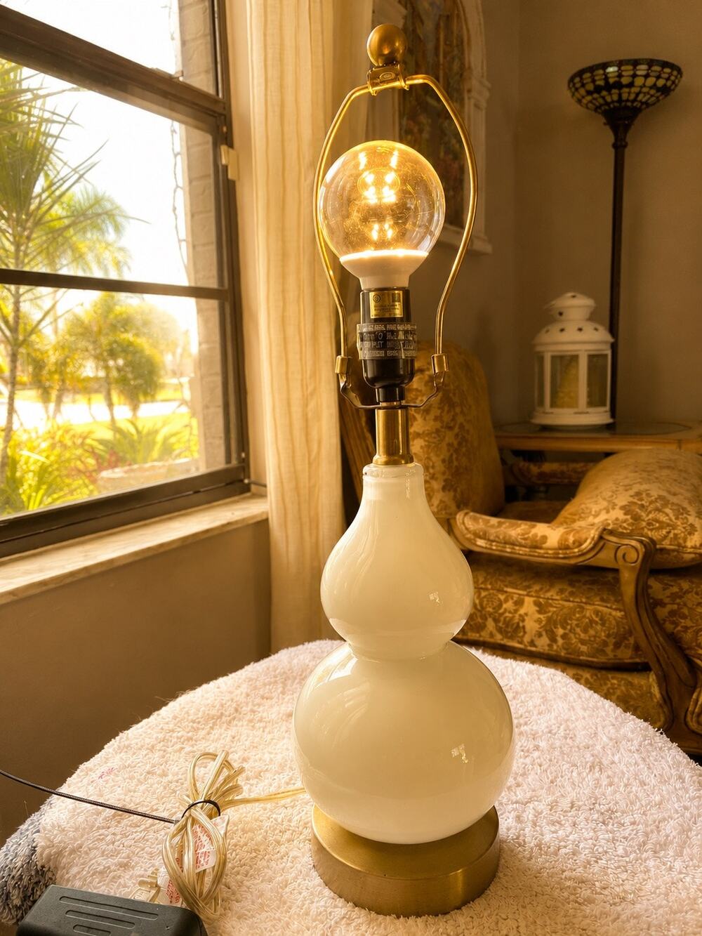 Jonathan Y Owen table lamp features a white glass double-gourd body set upon